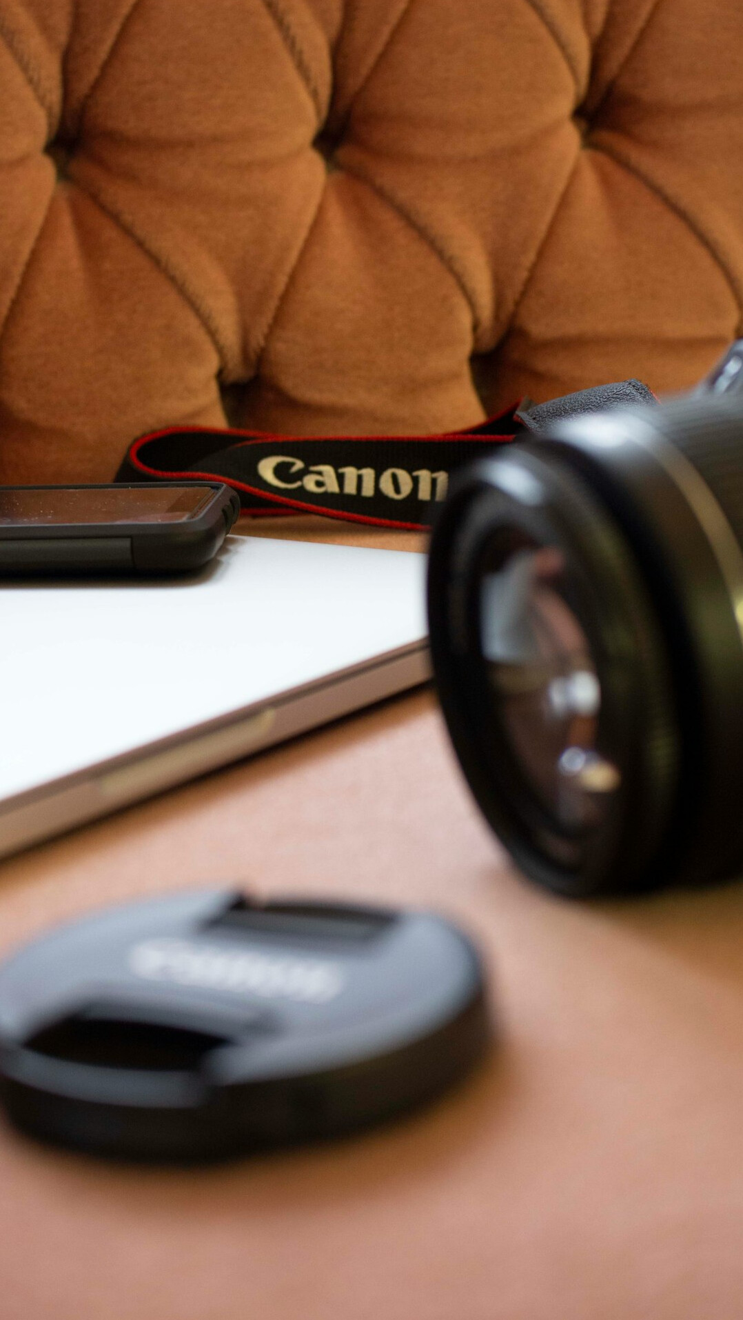 Camera, notebook and coffee cup on a wooden desk