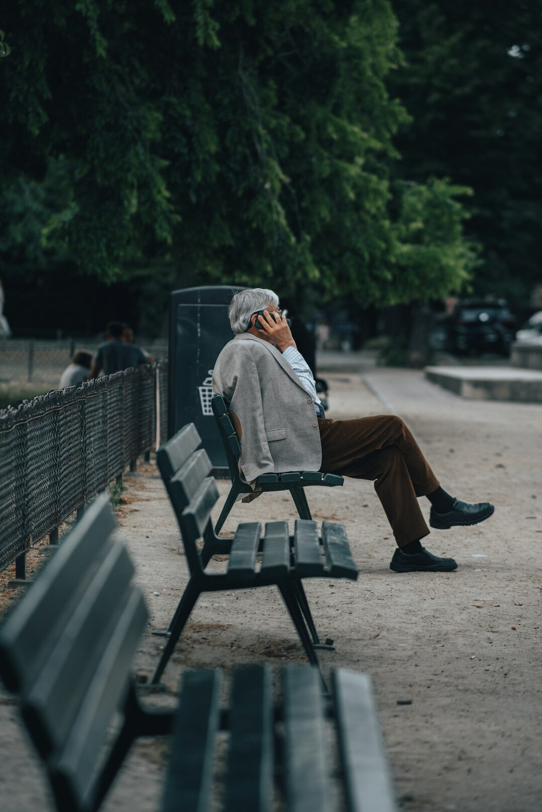 elderly man telling story on bench