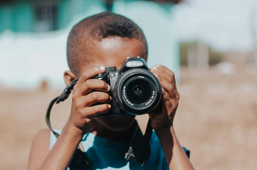 young photographer holding camera