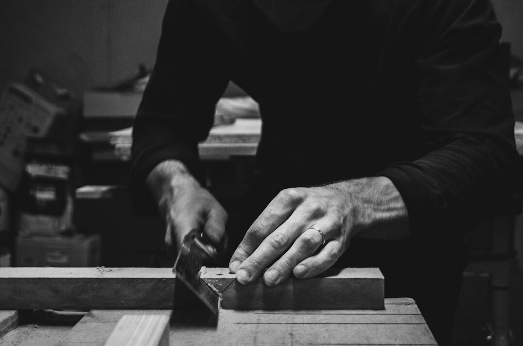 Polish craftsman working with wood in a small workshop